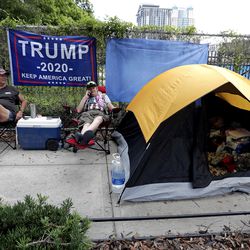 Anna Connelly, left, and Jeanna Gullett supporters of President Donald Trump, make camp Monday, June 17, 2019, in Orlando, Fla. as they wait to attend a rally for the president on Tuesday evening. (AP Photo/John Raoux)