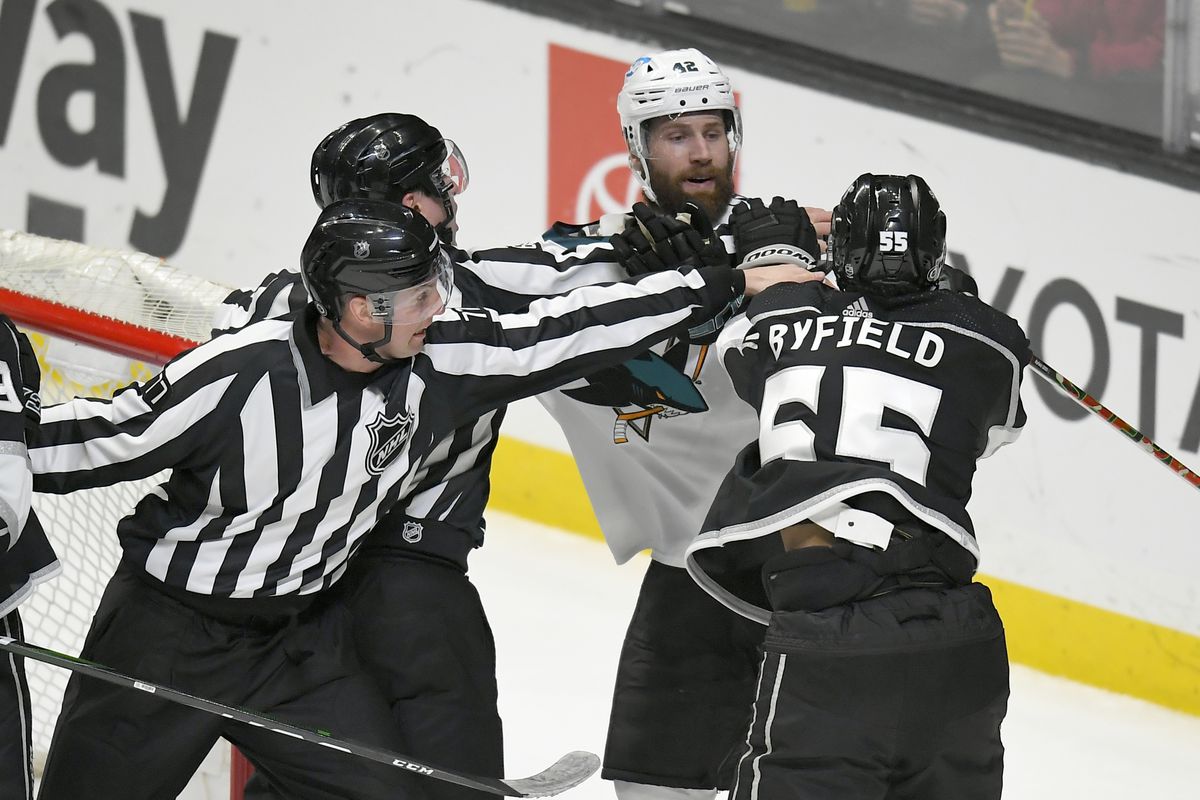 Refs stop a fight between San Jose Sharks left wing Jonah Gadjovich (42) and Los Angeles Kings center Quinton Byfield (55) during the Los Angeles Kings game versus the San Jose Sharks on March 10, 2022, at Crypto.com Arena in Los Angeles, CA.
