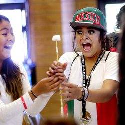 Claudia Monreal, right, reacts with friend Valeria Coles as their spaghetti, tape and string tower begins to tip as they and other Latino youth take part in the first-ever Statewide Leadership Boot Camp at Camp Tracy in Millcreek Canyon on Tuesday, July 26, 2016.