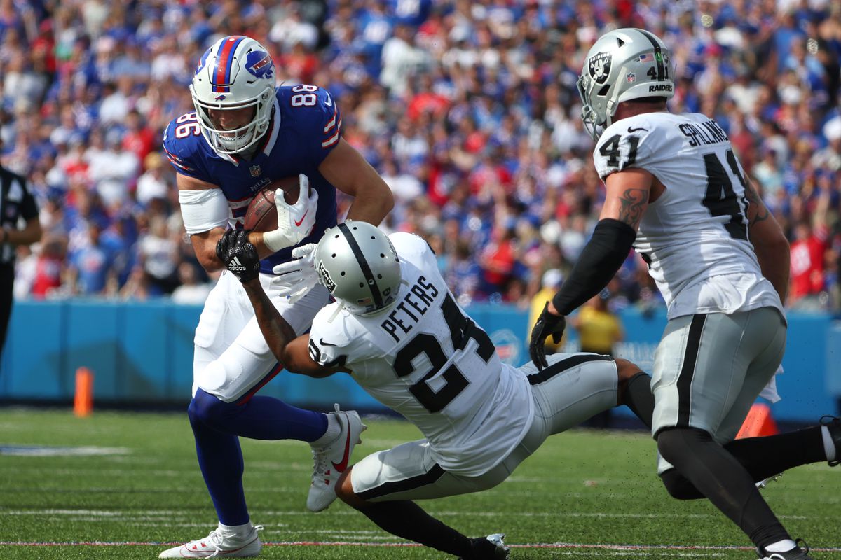 Dalton Kincaid of the Buffalo Bills runs the ball as Marcus Peters of the Las Vegas Raiders makes a tackle during a game at Highmark Stadium on September 17, 2023 in Orchard Park, New York.