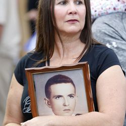 Irma Villar holds a photo of her uncle Lorenzo Perez Lorenzo, who was killed in the Bay of Pigs invasion, as she attends a rally, Wednesday, Nov. 30, 2016, in the Little Havana neighborhood of Miami. Hundreds of Cuban exiles in Miami rallied Wednesday for freedom and democracy on the communist island following the death of revolutionary leader Fidel Castro. 
