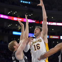 Los Angeles Lakers forward Pau Gasol, right, of Spain, shoots as San Antonio Spurs forward Matt Bonner defends during the first half in Game 4 of a first-round NBA basketball playoff series, Sunday, April 28, 2013, in Los Angeles. 