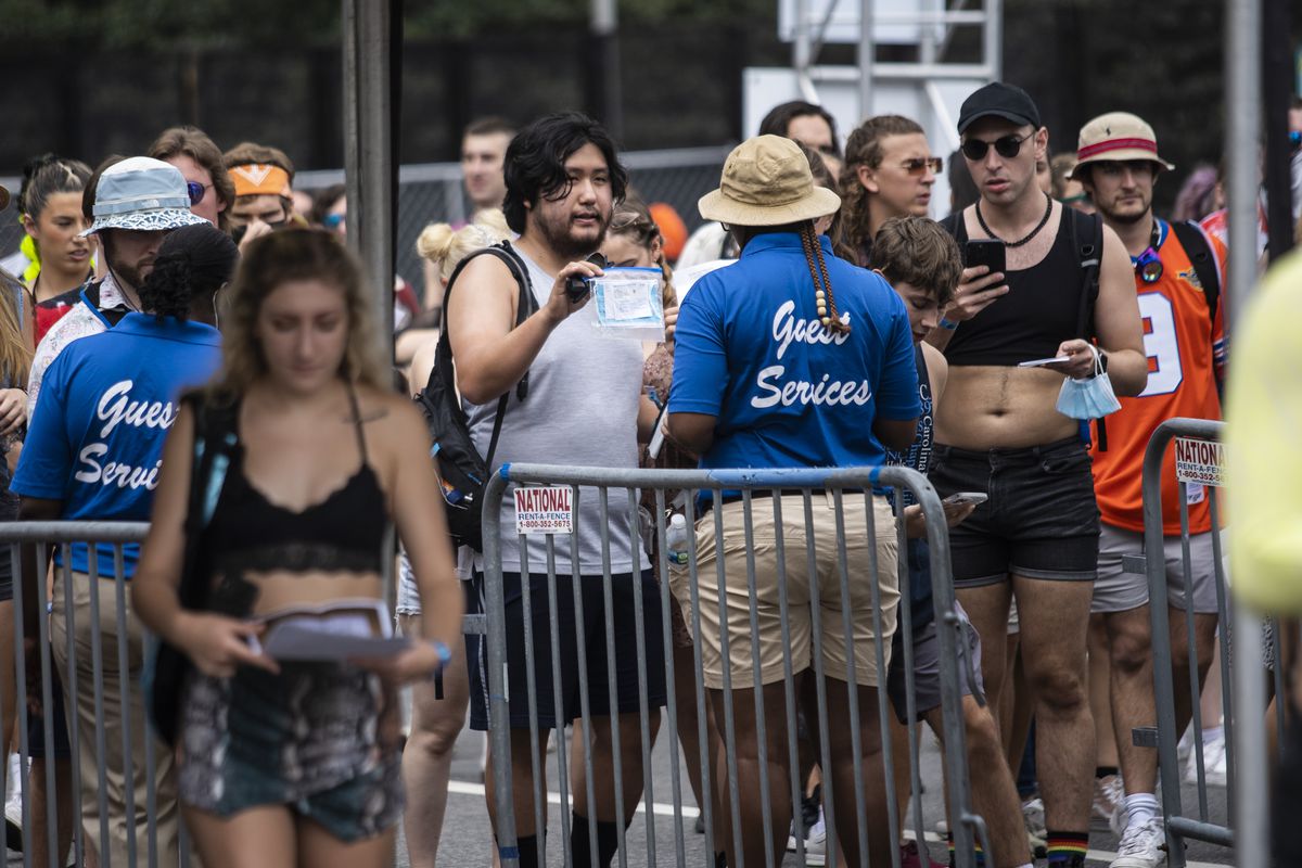 Festival-goers show proof of COVID-19 vaccination as they pass through a health screening station Thursday at the main entrance on Michigan Avenue on day one of Lollapalooza in Grant Park.