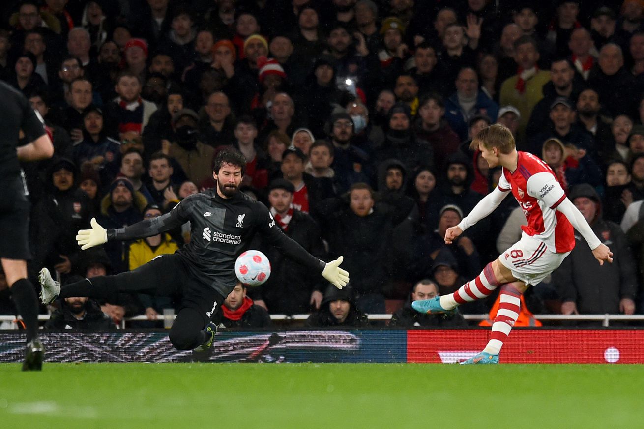 Alisson Becker of Liverpool makes a save during the Premier League match between Arsenal and Liverpool at Emirates Stadium on March 16, 2022 in London, England.