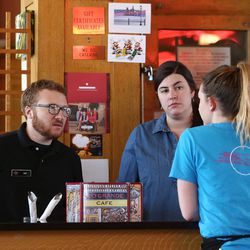 Ian Henderson, manager at the Rio Grande Cafe in Salt Lake City, talks with Anna Matriss and Colleen Murphey on Tuesday, Dec. 13, 2016.