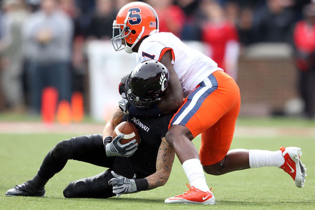 CINCINNATI - OCTOBER 30:  D J Woods #3 of the Cincinnati Bearcats is tackled by Phillip Thomas #1 of the Syracuse Orange during the Big East Conference game at Nippert Stadium on October 30 2010 in Cincinnati Ohio.  (Photo by Andy Lyons/Getty Images)