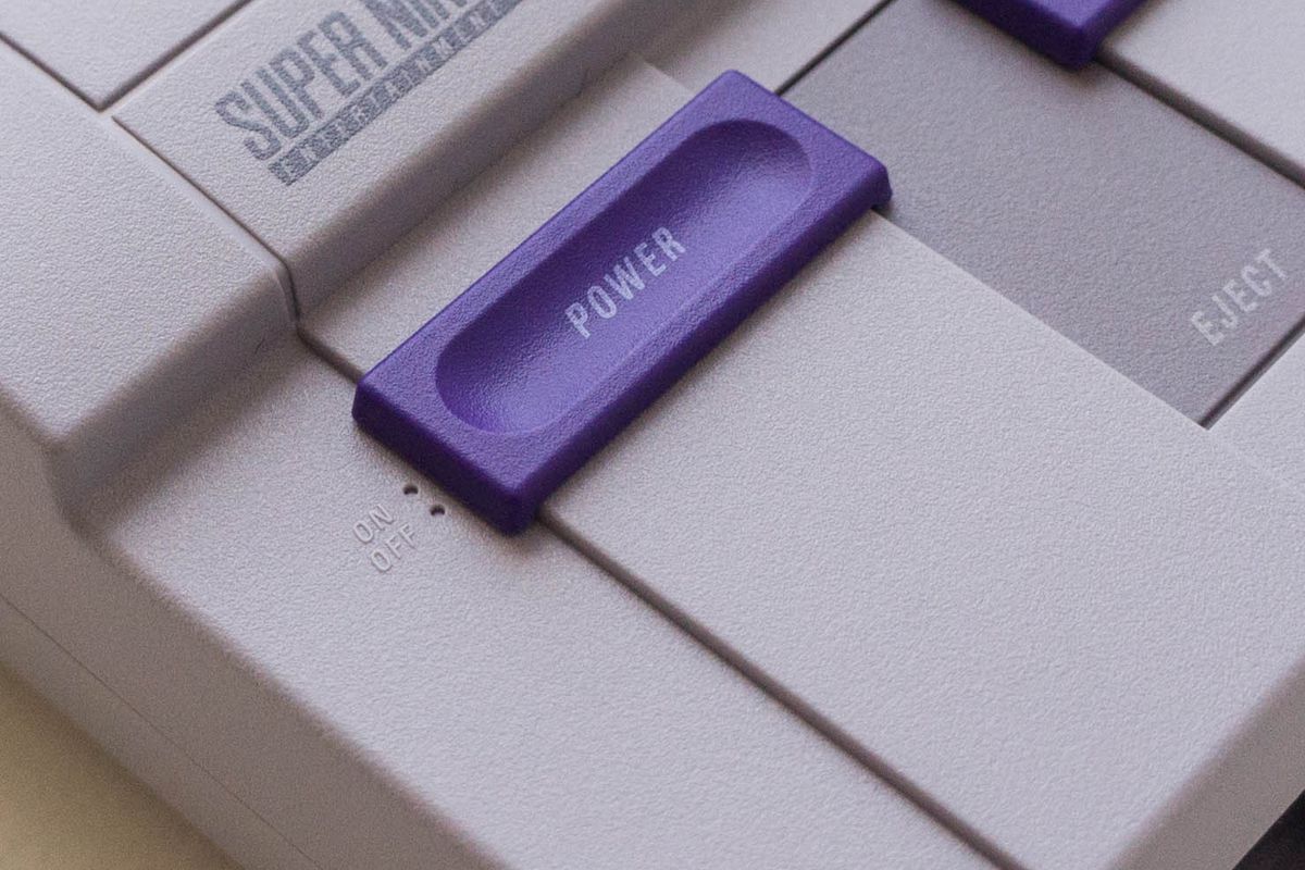 SNES Classic Edition - left top angle view, close-up of power switch in ‘on’ position