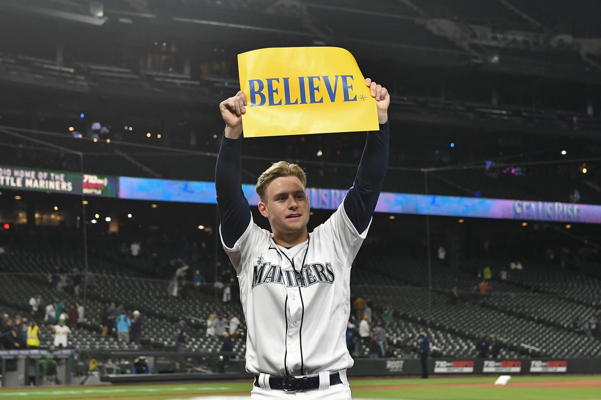 Jarred Kelenic holds up a “Believe” sign during the last week of the 2021 season