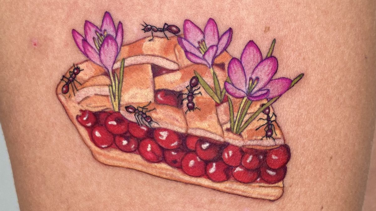 A tattoo of a piece of cherry pie, with flowers and ants.