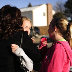 People embrace outside Deer Creek Middle School in Littleton, Colo. after a shooting on Tuesday.