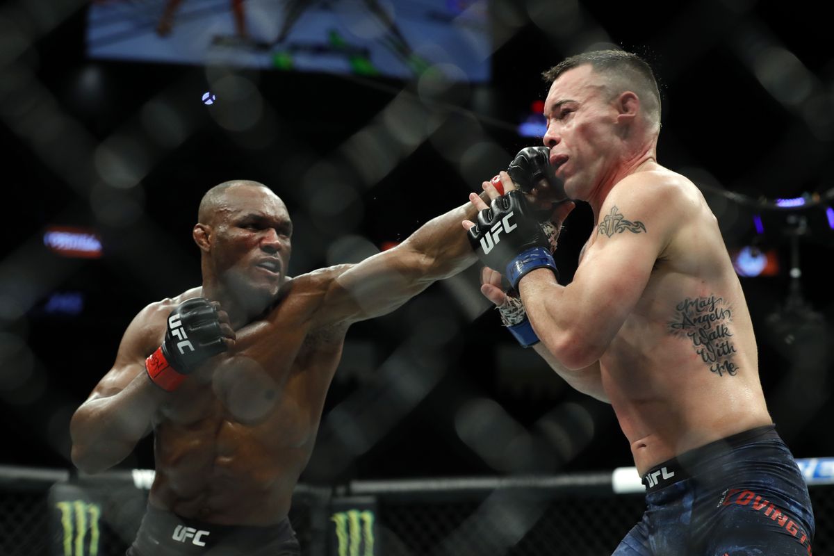 UFC welterweight champion Kamaru Usman (L) punches Colby Covington in their welterweight title fight during UFC 245 at T-Mobile Arena on December 14, 2019 in Las Vegas, Nevada.