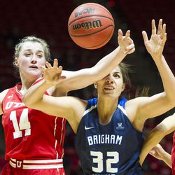Utah guard Paige Crozon (14) and Brigham Young forward Kalani Purcell (32) fight for the ball during an NCAA women's college basketball game in Salt Lake City on Saturday, Dec. 10, 2016. Utah defeated rival Brigham Young 77-60.