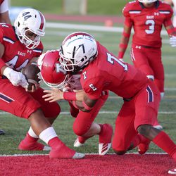 American Fork’s Maddux Madsen scores a touchdown as he gets tackled by East High’s Sau Tafisi (44) and Nicolas Session (7) during a football game at East High School in Salt Lake City on Friday, Sept. 6, 2019.