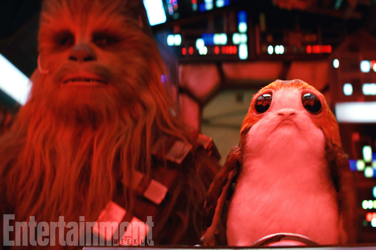Star Wars: The Last Jedi - A porg perched next to Chewbacca in the cockpit of the Millennium Falcon