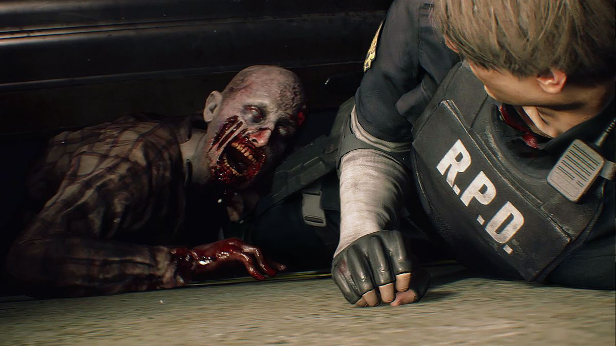 Resident Evil 2 (2019) - a zombie attacks Leon Kennedy on the ground