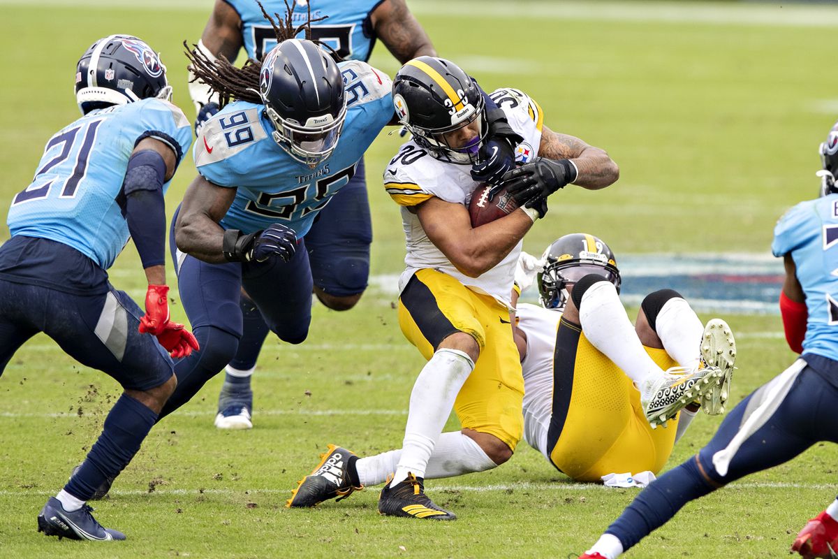 James Conner #30 of the Pittsburgh Steelers is tackled in the second half by Jadeveon Clowney #99 of the Tennessee Titans at Nissan Stadium on October 25, 2020 in Nashville, Tennessee.&nbsp;
