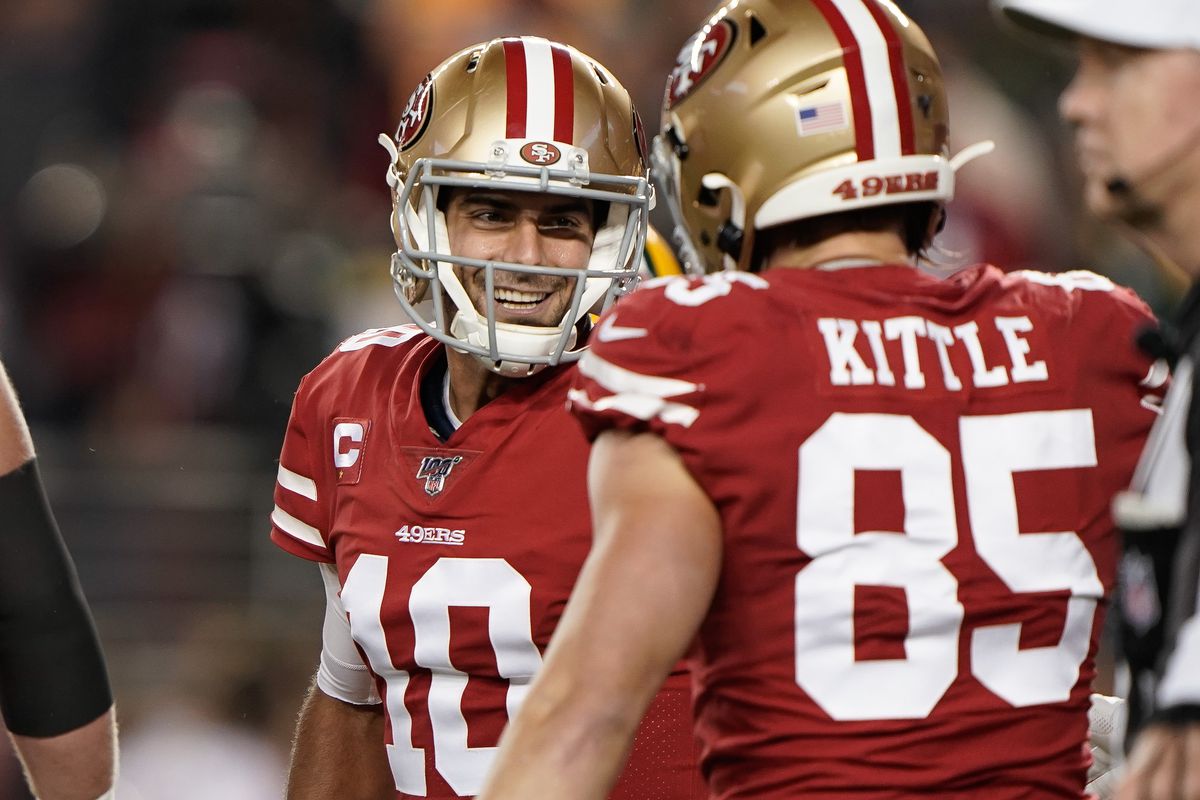 San Francisco 49ers quarterback Jimmy Garoppolo smiles at tight end George Kittle in the game against the Green Bay Packers during the first quarter at Levi’s Stadium.