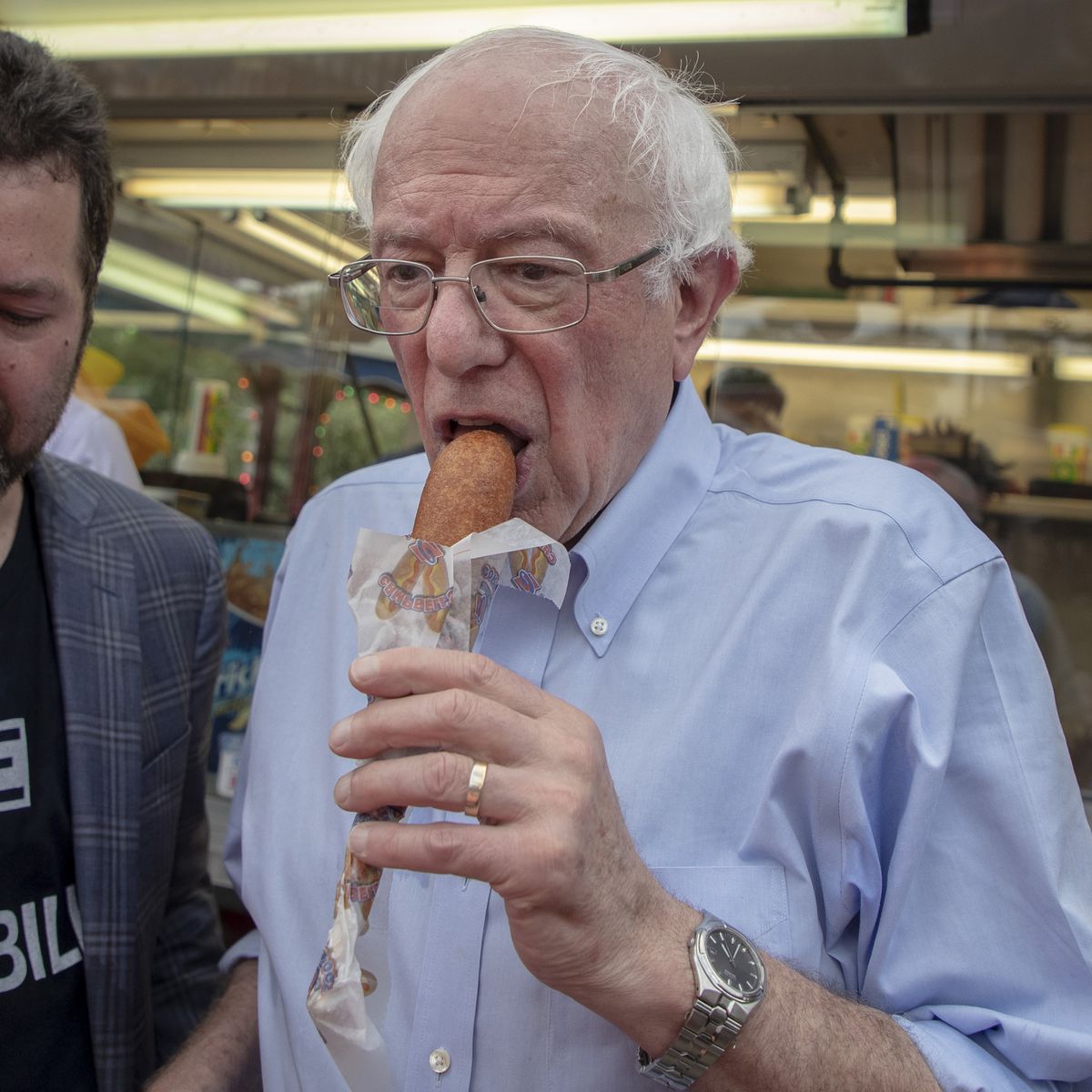 Presidential candidate Bernie Sanders takes a bite of a corn dog