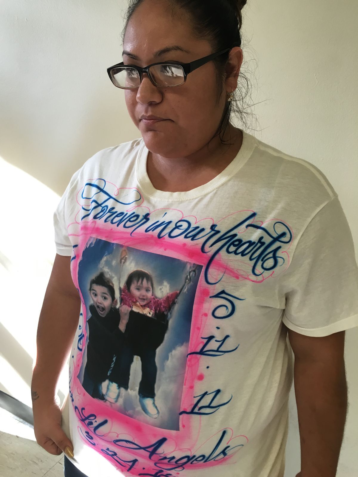 Bernice Cabrera shows the shirt that bears pictures of her children, 10-month-old Julissa Ochoa and 5-year-old Eric Ochoa Jr., who were killed in a DUI crash in 2012. | Rummana Hussain/For the Sun-Times