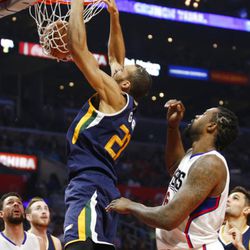 Utah Jazz center Rudy Gobert, left, dunks the ball in front of Los Angeles Clippers center DeAndre Jordan, right, during the first half of an NBA basketball game, Saturday, March 25, 2017, in Los Angeles. (AP Photo/Danny Moloshok)