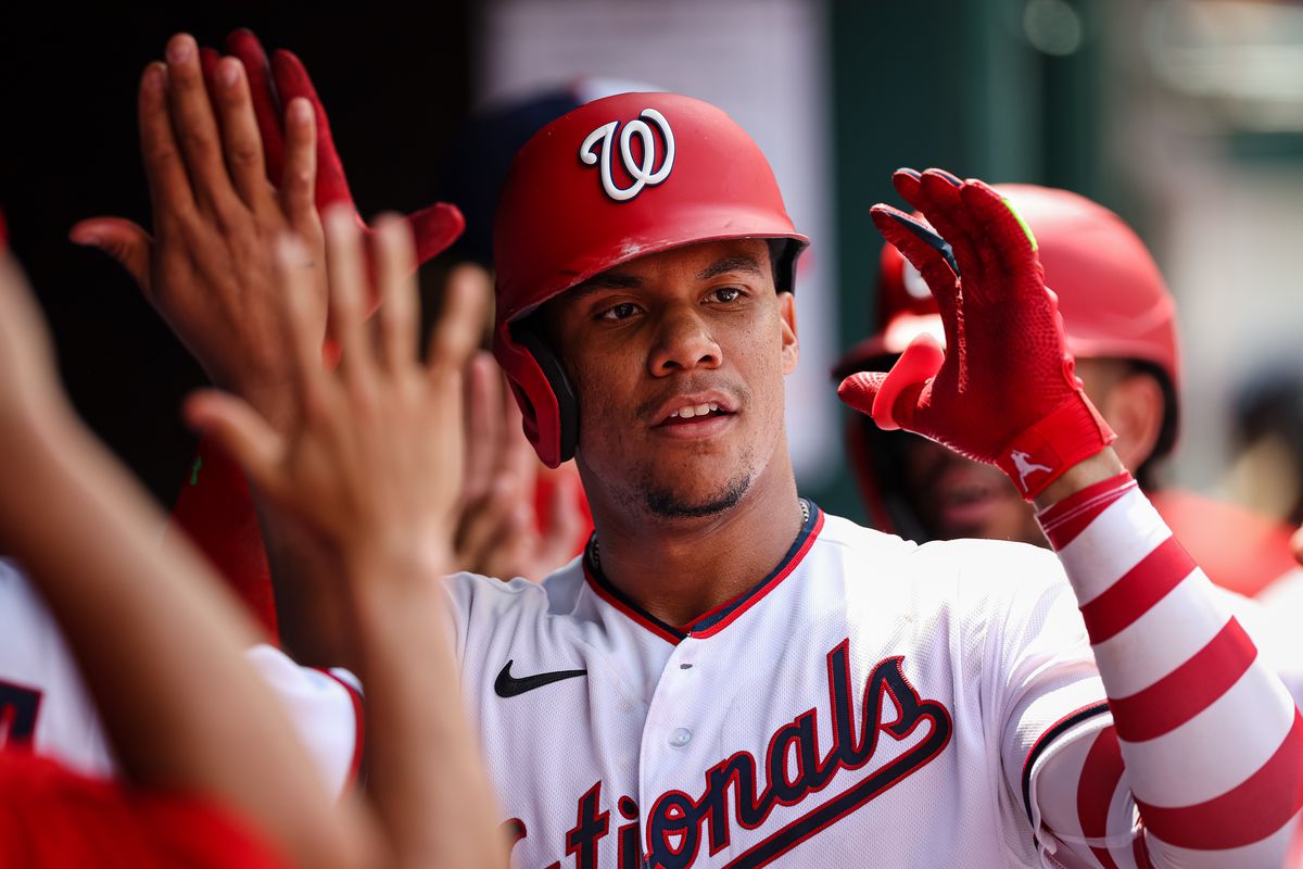 Juan Soto #22 of the Washington Nationals celebrates with teammates after hitting a three run home run against the Seattle Mariners during the ninth inning of game one of a doubleheader at Nationals Park on July 13, 2022 in Washington, DC.