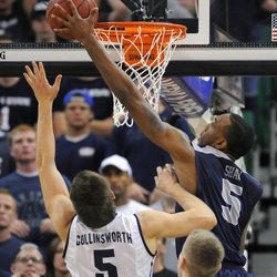 Utah State Aggies center Jarred Shaw (5) grabs a rebound in front of Brigham Young Cougars guard Kyle Collinsworth (5) during a game at EnergySolutions Arena on Saturday, November 30, 2013.