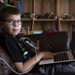 Oliwier “Oli” Kluzik, 12, plays Minecraft at his grandmother’s Northwest Side home, Thursday afternoon, Sept. 12, 2019.