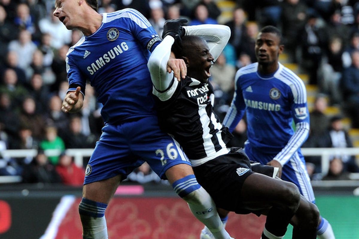 Demba Ba of Newcastle United tangles with John Terry of Chelsea during the Barclays Premier League match between Newcastle United and Chelsea at the Sports Direct Arena in Newcastle, England. (Photo by Gareth Copley/Getty Images)