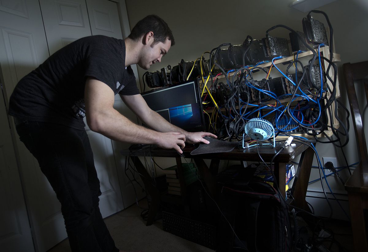Jacob Berezay adjusts his Ethereum mining setup in South Salt Lake on Thursday, Dec. 28, 2017.