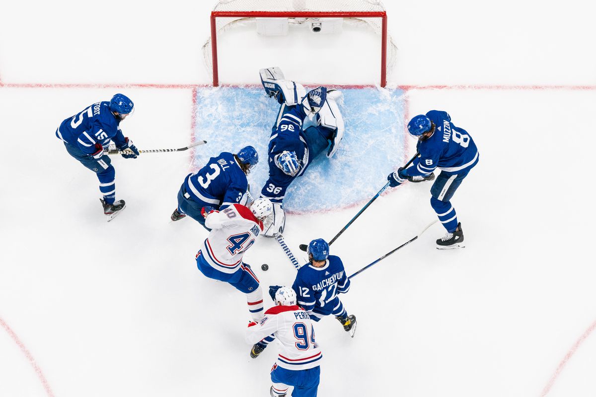 Jack Campbell #36 of the Toronto Maple Leafs attempts to clear the puck against Joel Armia #40 of the Montreal Canadiens during the third period in Game Five of the First Round of the 2021 Stanley Cup Playoffs at the Scotiabank Arena on May 27, 2021 in Toronto, Ontario, Canada.