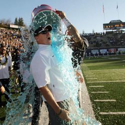 FILE -- Utah State University coach Gary Andersen reacts to the cold gatorade after beating Idaho to win the WAC Championship  in Logan Nov 24, 2012. Andersen left the Aggies to become the head coach at Wisconsin after the 2012 season.