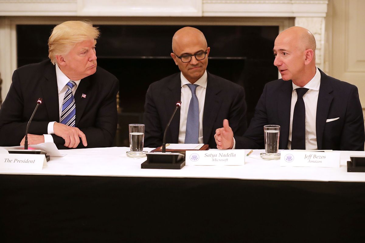 U.S. President Donald Trump, Microsoft CEO Satya Nadella and Amazon CEO Jeff Bezos attend a meeting of the American Technology Council in the State Dining Room of the White House June 19, 2017 in Washington, DC.