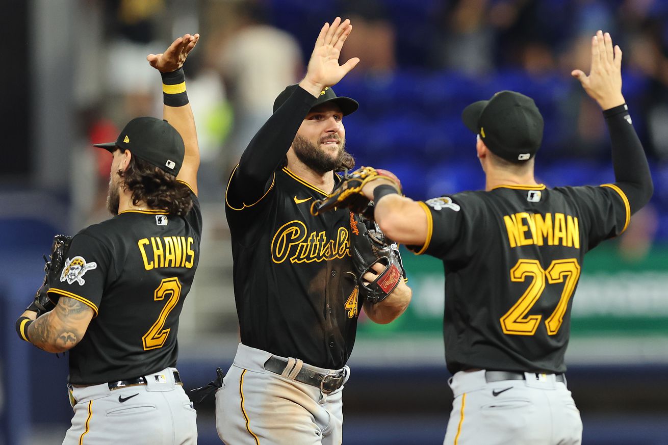 Michael Chavis #2, Jake Marisnick #41, and Kevin Newman #27 of the Pittsburgh Pirates celebrate after defeating the Miami Marlins 5-1 at loanDepot park on July 11, 2022 in Miami, Florida.
