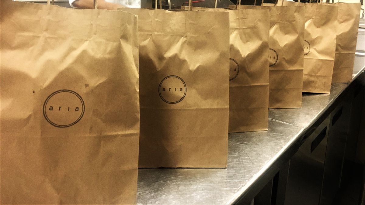 Takeout bags line a counter in the kitchen at Aria in Buckhead, Atlanta