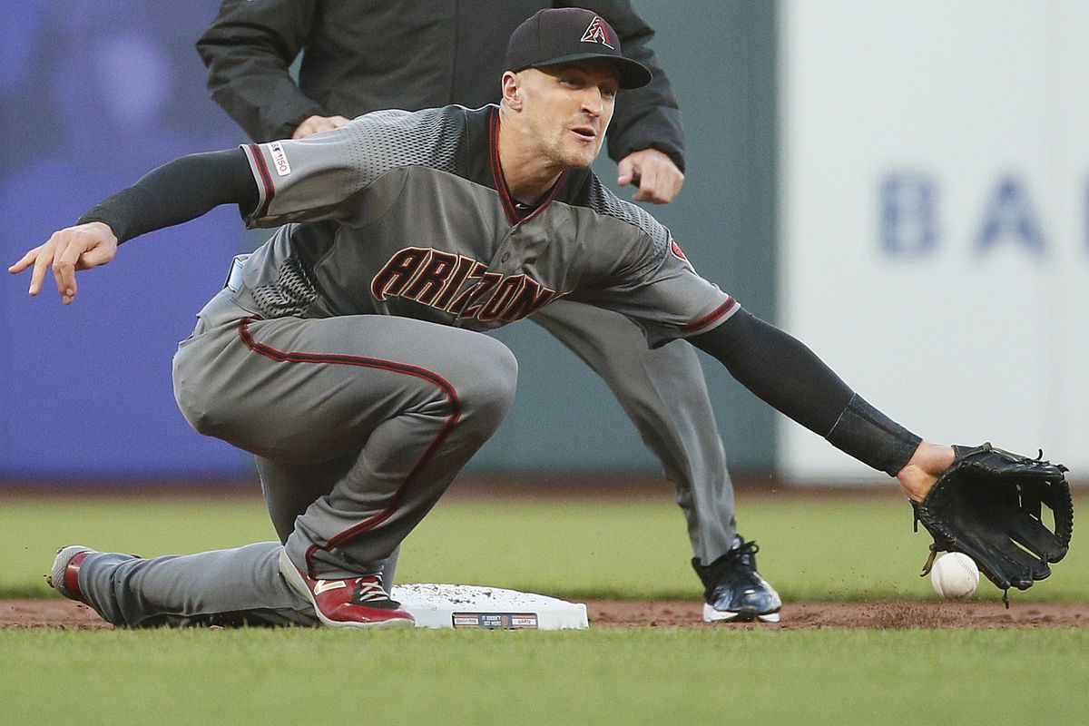 Arizona Diamondbacks shortstop Nick Ahmed (13) gloves the ball and gets San Francisco Giants left fielder Mike Yastrzemski (5) out after he tried to steal second base in the 1st inning of an MLB game at Oracle Park on Saturday, June 29, 2019, in San Franc