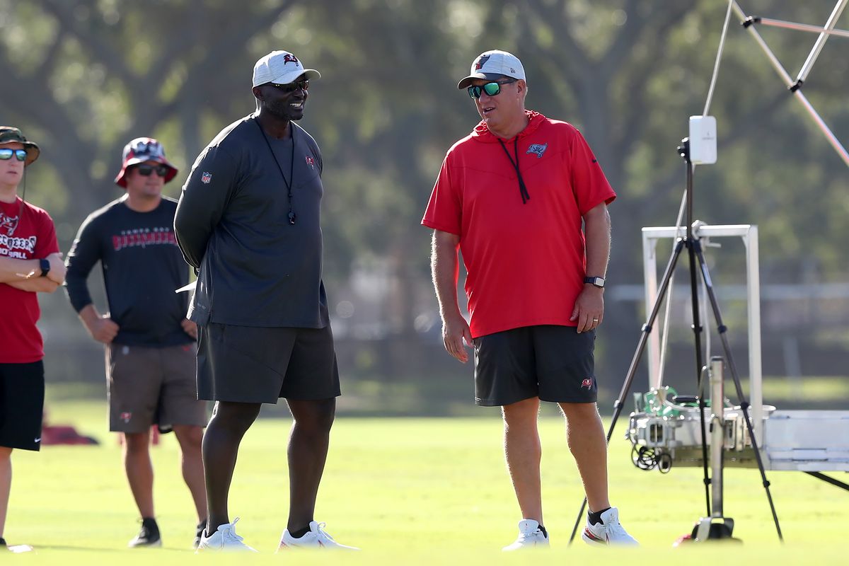 Tampa Bay Buccaneers Head Coach Todd Bowles and General Manager Jason Licht watch the action on the field during the Tampa Bay Buccaneers Training Camp on August 07, 2022 at the AdventHealth Training Center at One Buccaneer Place in Tampa, Florida.