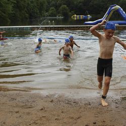 Swimmers exit the water at the fourth annual Race4Chase kids triathlon finale in Southington, Conn. on Saturday, Aug. 5, 2017. The program, founded by the family of a Chase Kowalski, who was killed in the Sandy Hook shootings has grown to more than 20 sites in three states. 