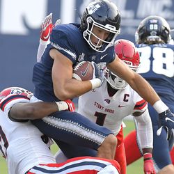 Utah State tight end Caleb Repp (87) gets tackled by Stony Brook linebacker Elijah Duff and defensive back Gavin Heslop (1) during an NCAA college football game, Saturday, Sept. 7, 2019, in Logan, Utah. 