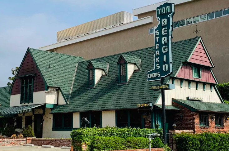 The classic exterior of Tom Bergin’s Irish pub, complete with green sign and brick.