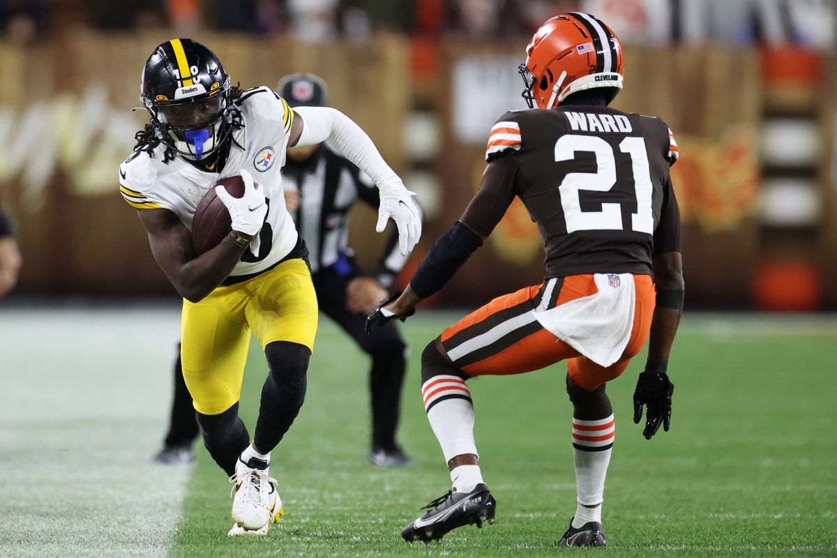 Diontae Johnson of the Pittsburgh Steelers makes a reception ahead of Denzel Ward of the Cleveland Browns during the third quarter at FirstEnergy Stadium on September 22, 2022 in Cleveland, Ohio.
