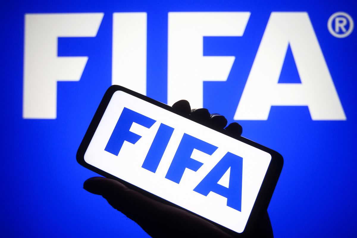 In this photo illustration, FIFA logo is seen on a...