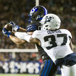 Brigham Young wide receiver Mitchell Juergens (87) secures a pass for a touchdown in front of Utah State safety Devin Centers (37) during an NCAA college football game in Provo on Saturday, Nov. 26, 2016. Brigham Young defeated in-state foe Utah State 28-10.