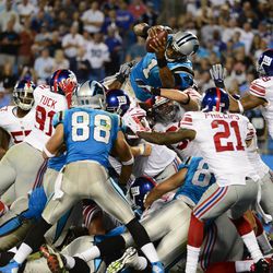 Cam Newton goes over the top of the pile to score a touchdown in the Carolina Panthers' Thursday night loss to the New York Giants.
