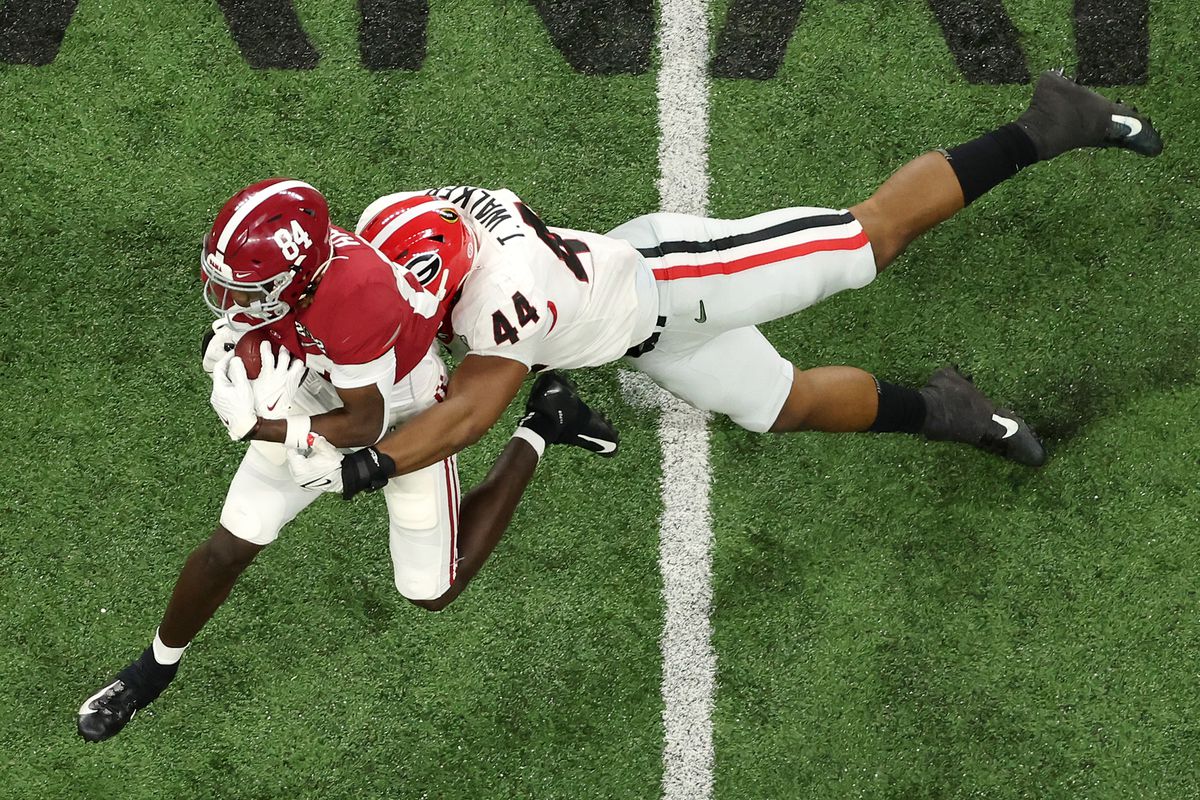 Travon Walker #44 of the Georgia Bulldogs tackles Agiye Hall #84 of the Alabama Crimson Tide during the second quarter in the 2022 CFP National Championship Game at Lucas Oil Stadium on January 10, 2022 in Indianapolis, Indiana.