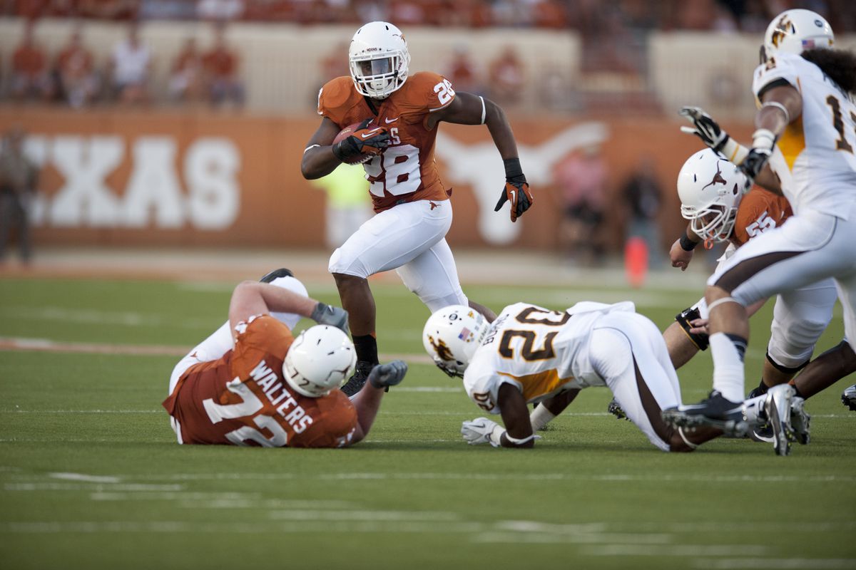 AUSTIN, TX - SEPTEMBER 1: Malcolm Brown #28 of the Texas Longhorns breaks a tackle during the against the Wyoming Cowboys on September 1, 2012 at Darrell K Royal-Texas Memorial Stadium in Austin, Texas.  (Photo by Cooper Neill/Getty Images)