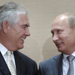 FILE- In this Aug. 30, 2011, file photo, Russian Prime Minister Vladimir Putin, right, and Rex Tillerson, ExxonMobil's chief executive smile during a signing ceremony in the Black Sea resort of Sochi, Russia. President-elect Donald Trump selected ExxonMobil CEO Rex Tillerson to lead the State Department on Monday, Dec. 12, 2016. (Alexei Druzhinin/RIA Novosti via AP, Pool)