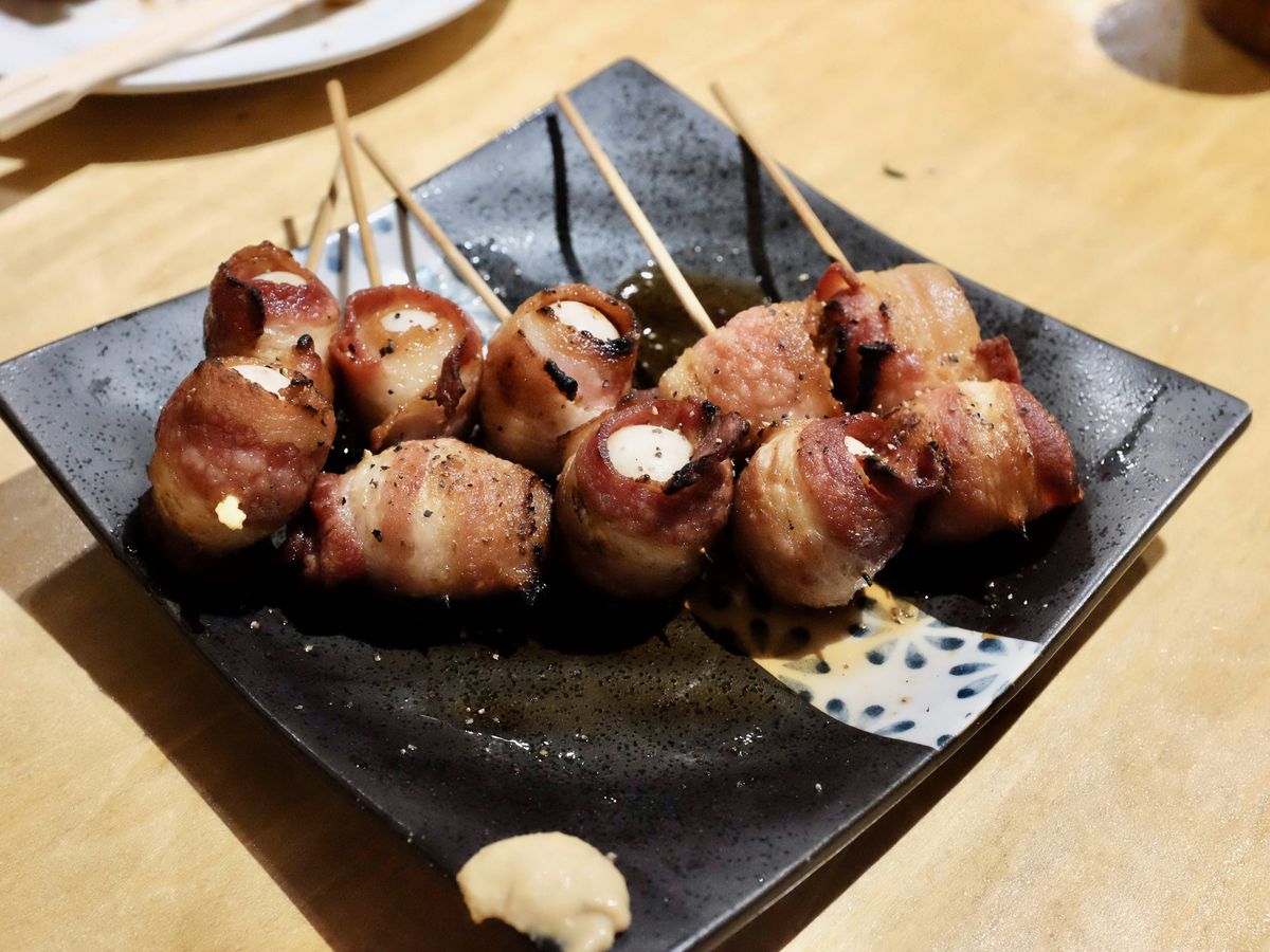 Skewers of quail on a plate.