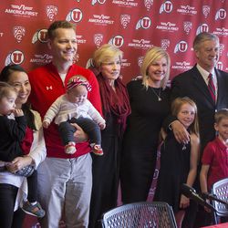 University of Utah athletic director Chris Hill, right, has pictures made with his family after he spoke at a press conference regarding his retirement after 31 years in the position at Jon M. Huntsman Center in Salt Lake City on Monday, March 26, 2018. Hill was 37 years old when he took the position in 1987.