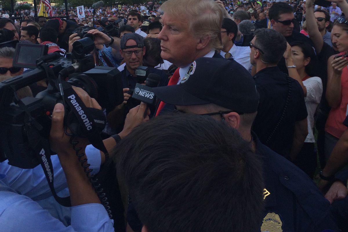 Donald Trump talks to reporters outside the Capitol at a rally against the nuclear deal with Iran on September 9, 2015.
