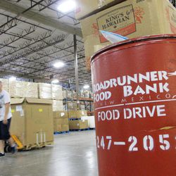 A volunteer moves a pallet of food at the Roadrunner Food Bank in Albuquerque, N.M., on Friday, June 21, 2013. The food bank distributes about 90,000 pounds of food a day to organizations that help low-income families. An annual survey released by the Annie E. Casey Foundation ranks New Mexico as worst in the nation when it comes to child well-being. More than 30 percent of children in the state were living in poverty in 2011. 